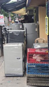 Appliances and crates on sidewalk